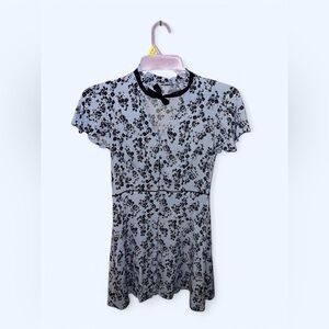 Blue floral coquette dress with black trim, short sleeves, and bow tie